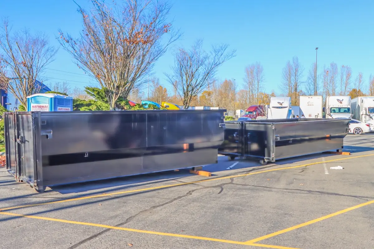 Professional dumpster rental service with roll-off container on residential driveway in Damascus